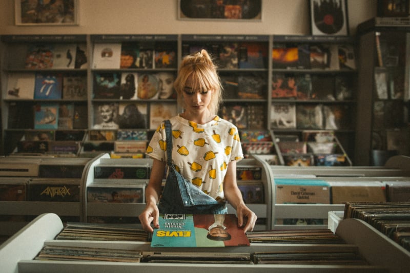 girl at a record store | best music for addiction on Spotify 